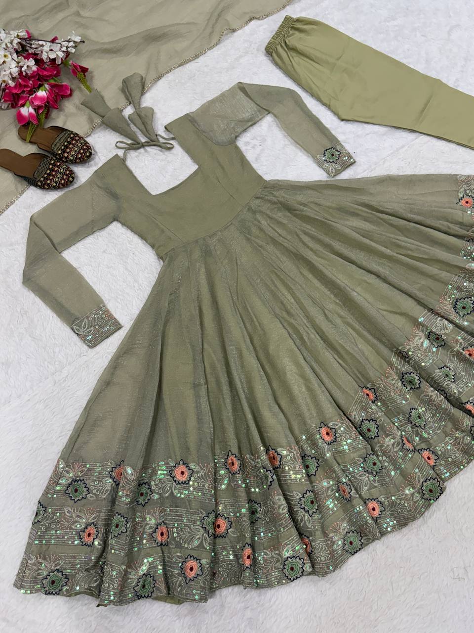 Ethereal Mehendi Green Flared Anarkali Suit Set Adorned with Luminous Sequined Floral Motifs, Embroidered Cuffs, and an Ornate Heritage Hem